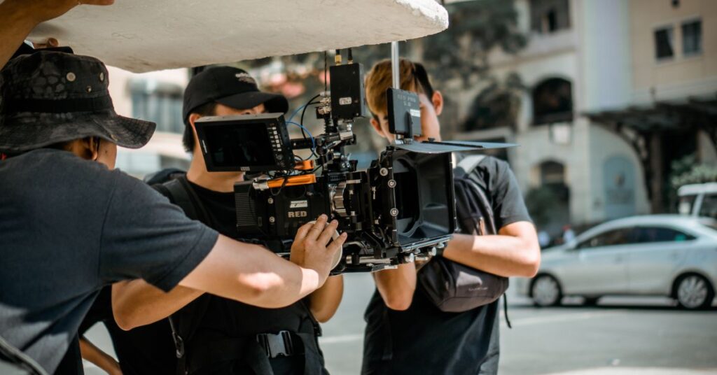 A videographer and crew at work on a bustling Johannesburg street, capturing dynamic scenes and collaborating to bring urban stories to life.