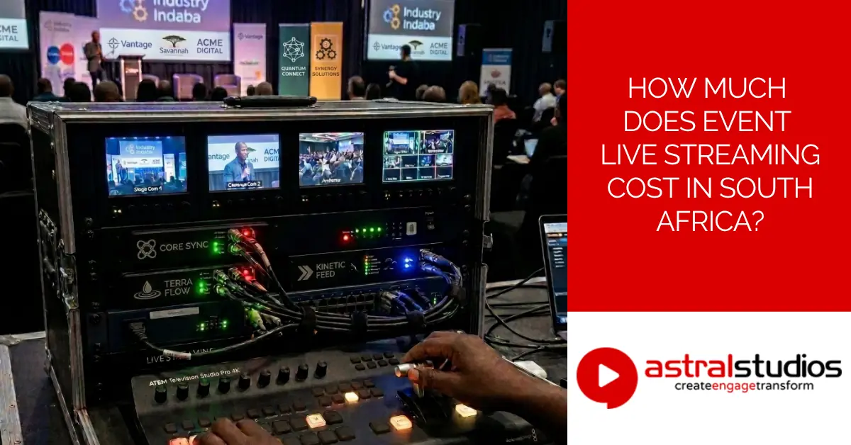 A live streaming operator works a multi-camera vision mixer at a corporate conference in South Africa, with multiple monitor feeds and encoding equipment visible in a flight case
