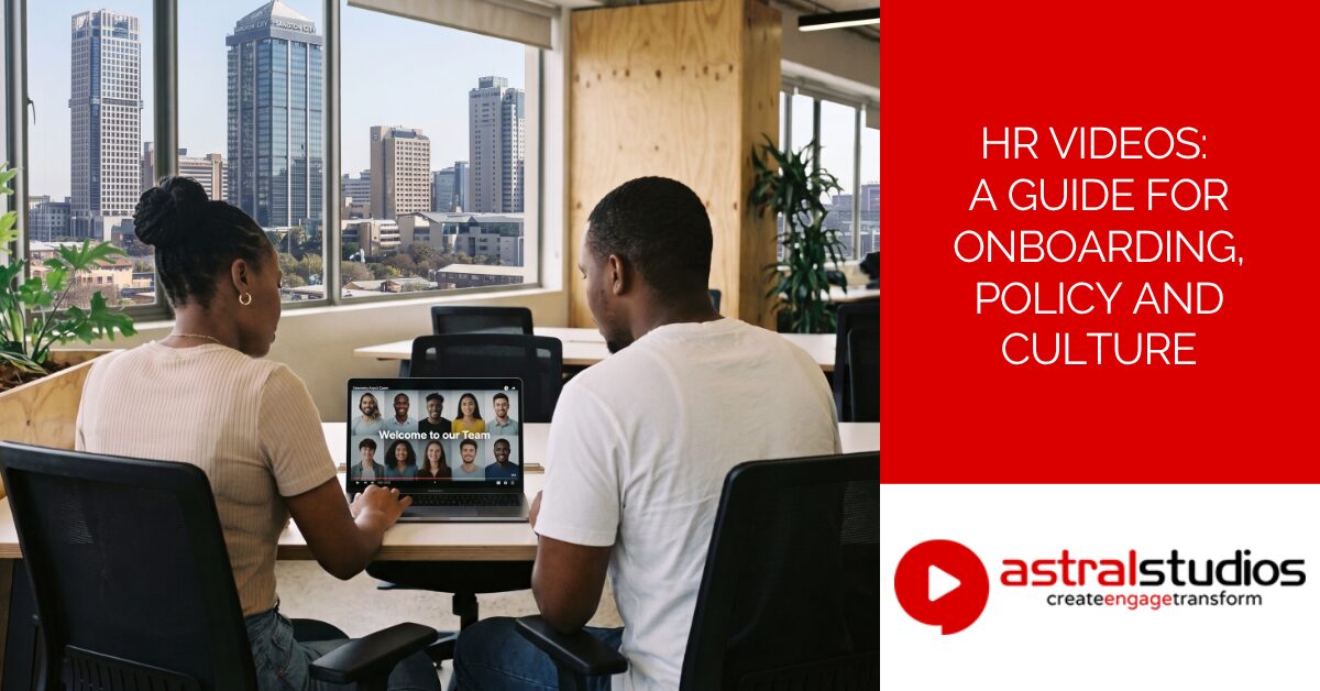 Two colleagues reviewing an onboarding video together on a laptop